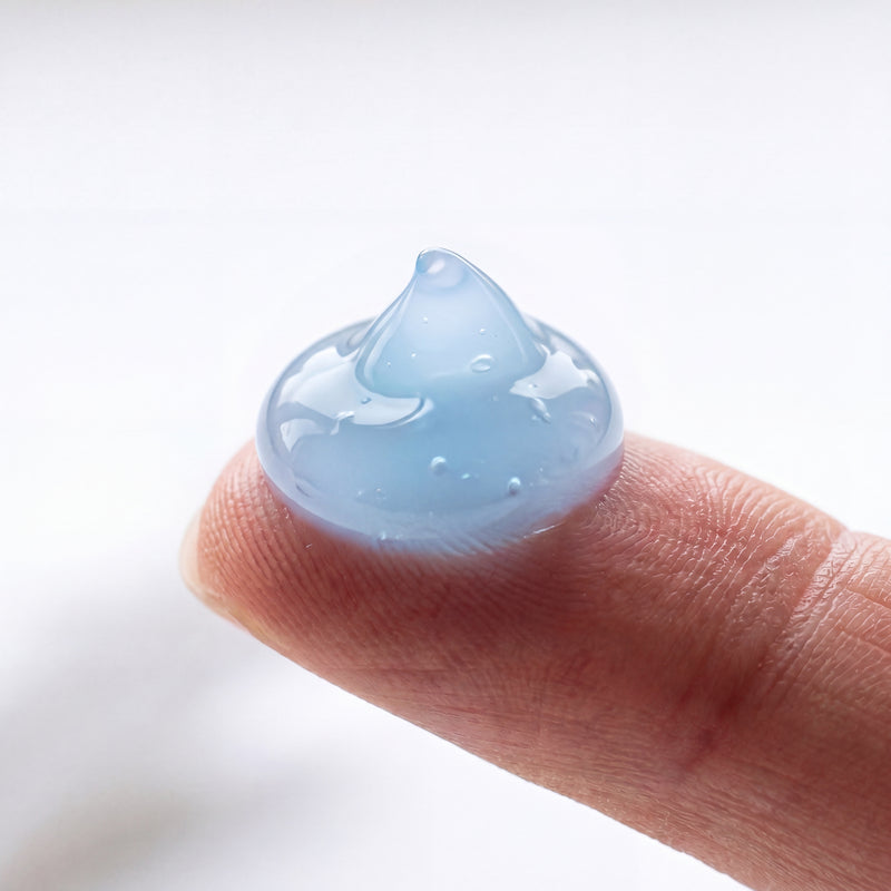 Blue copper-peptide gel texture on a fingertip - the blue color is the active GHK-Cu complex